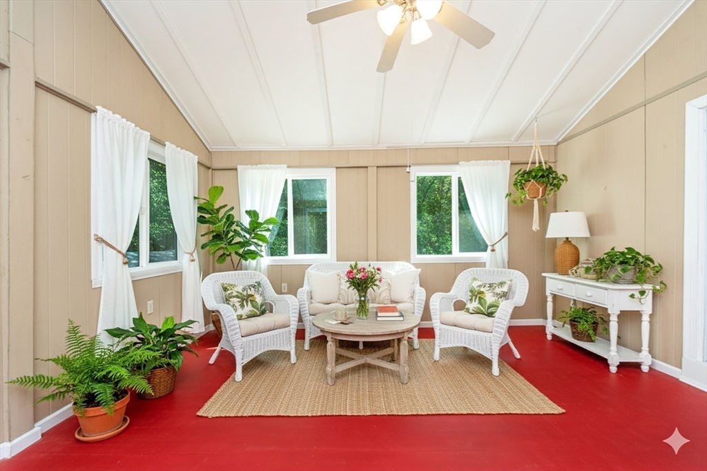 205 Beaman Road Sterling, MA 01564 - Photo 23 of 41 a living room with furniture potted plant floor to ceiling window and potted plants