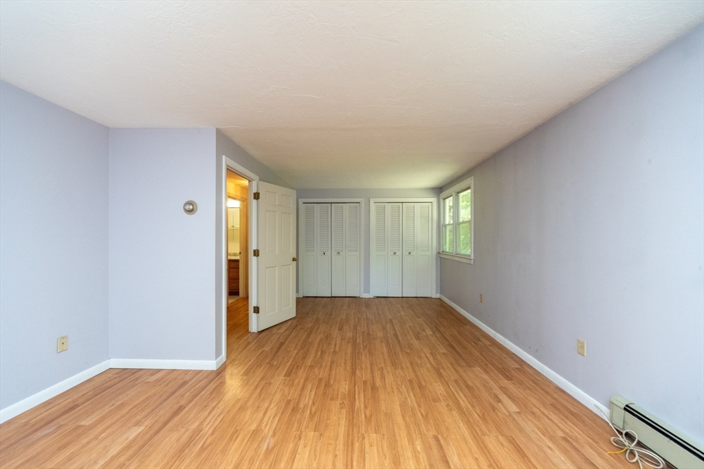 205 Beaman Road Sterling, MA 01564 - Photo 25 of 41 a view of a big room with wooden floor and windows