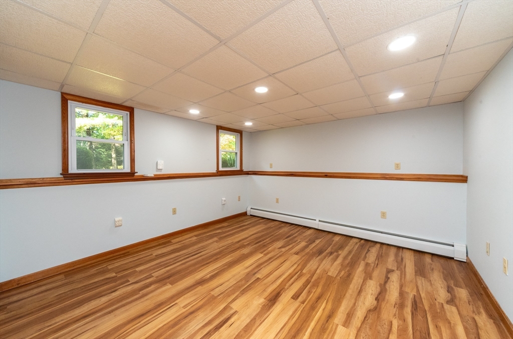 205 Beaman Road Sterling, MA 01564 - Photo 28 of 41 an empty room with wooden floor and windows