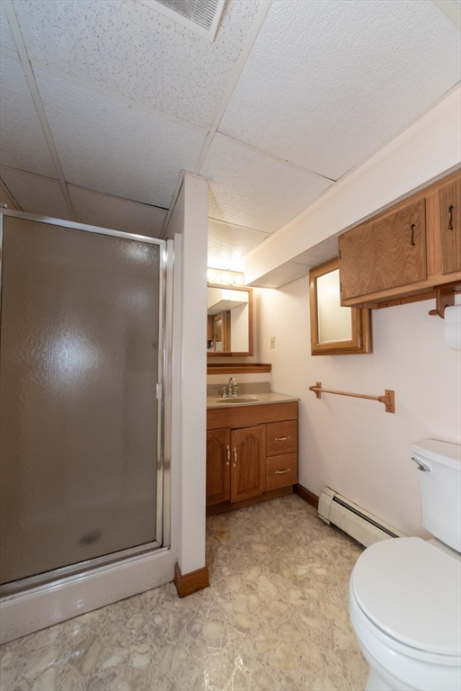 205 Beaman Road Sterling, MA 01564 - Photo 30 of 41 a bathroom with a granite countertop sink mirror vanity and toilet