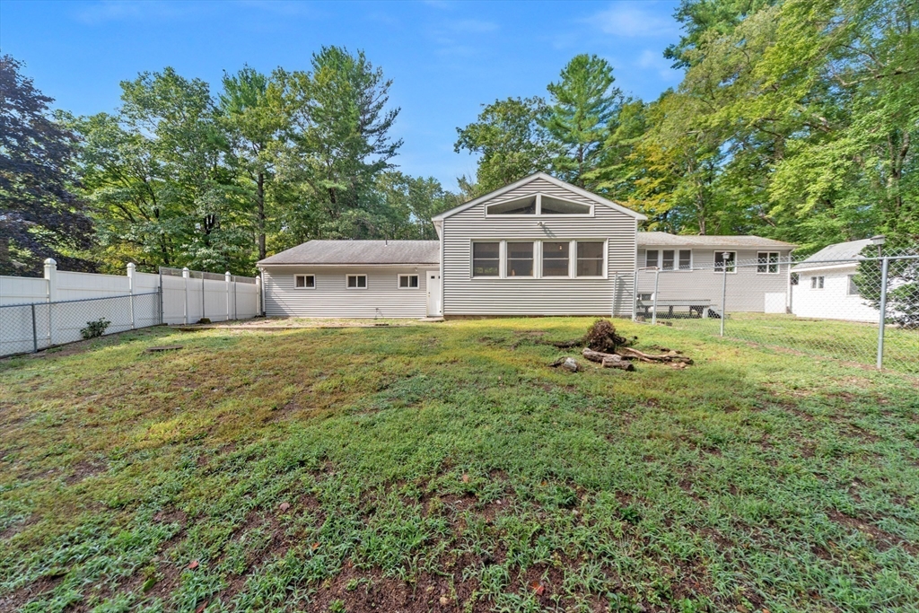 205 Beaman Road Sterling, MA 01564 - Photo 3 of 41 a house with green field in front of it