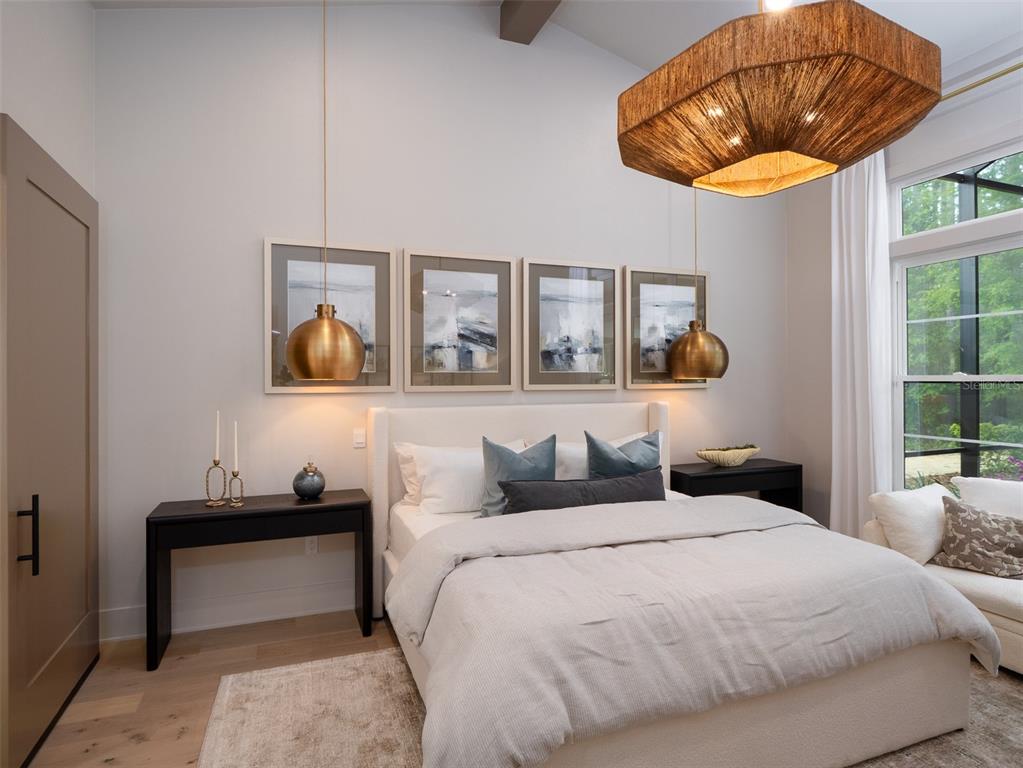 14828 Southwest 9th Lane Newberry, FL 32669 - Photo 21 of 45 a bedroom with a bed and a chandelier