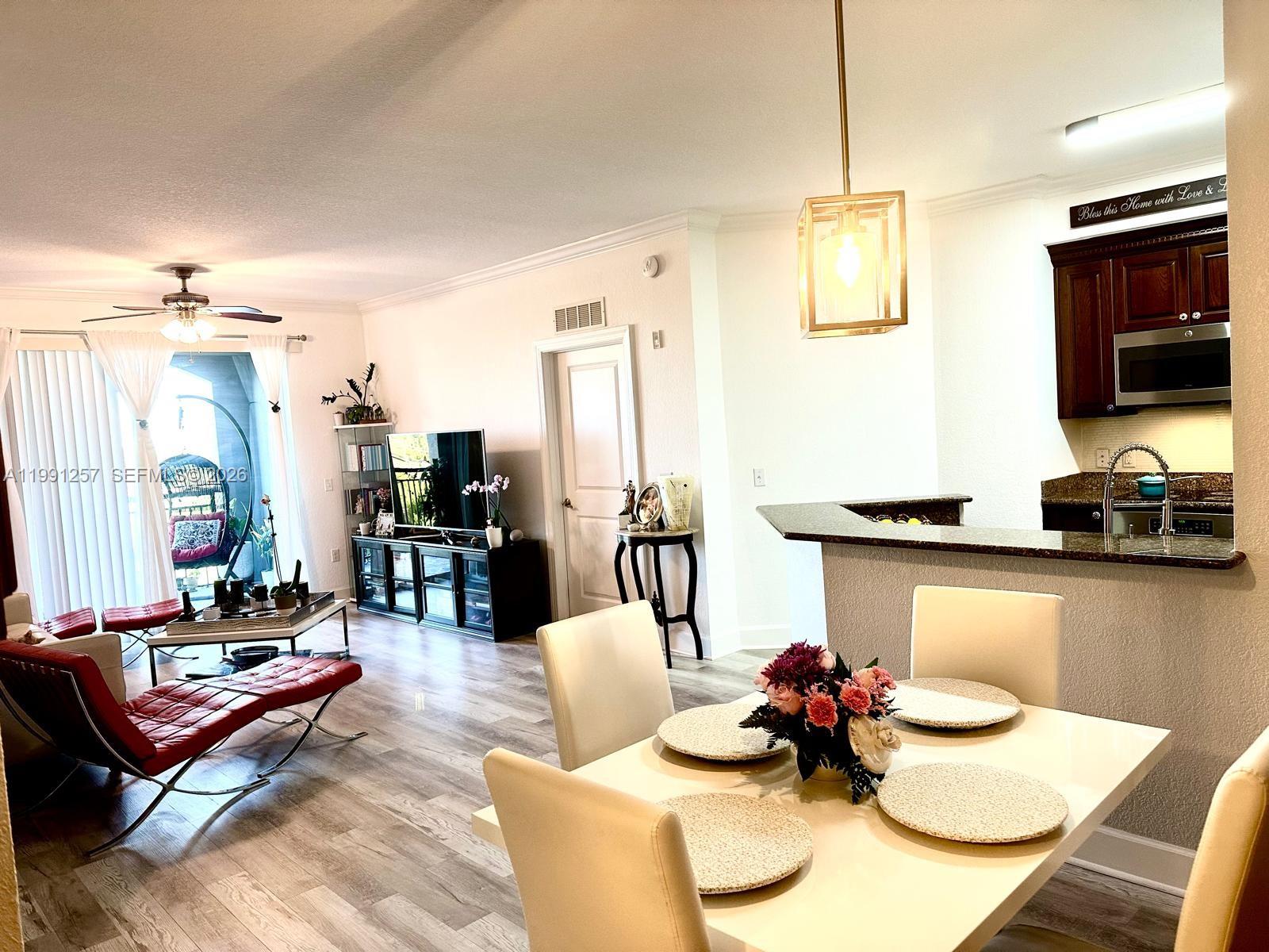 1660 Renaissance Commons Boulevard, Unit 2606 Boynton Beach, FL 33426 - Photo 12 of 26 a living room with furniture and kitchen view