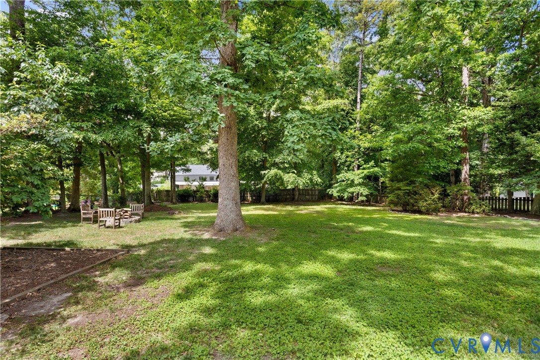 3136 Old Quarry Road Richmond, VA 23225 - Photo 23 of 39 Expansive backyard featuring a lush lawn, mature t