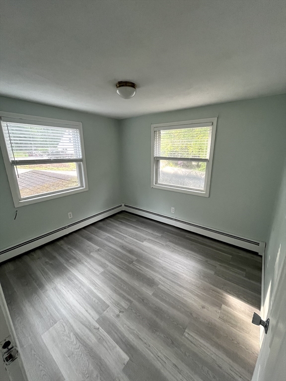 56 Shore Drive Upton, MA 01568 - Photo 11 of 23 a view of an empty room with wooden floor and a window