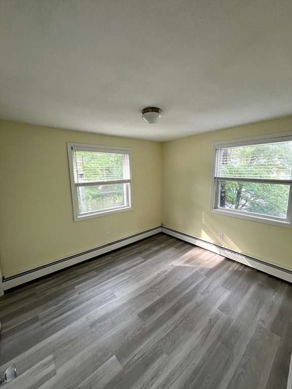 56 Shore Drive Upton, MA 01568 - Photo 12 of 23 an empty room with wooden floor and windows