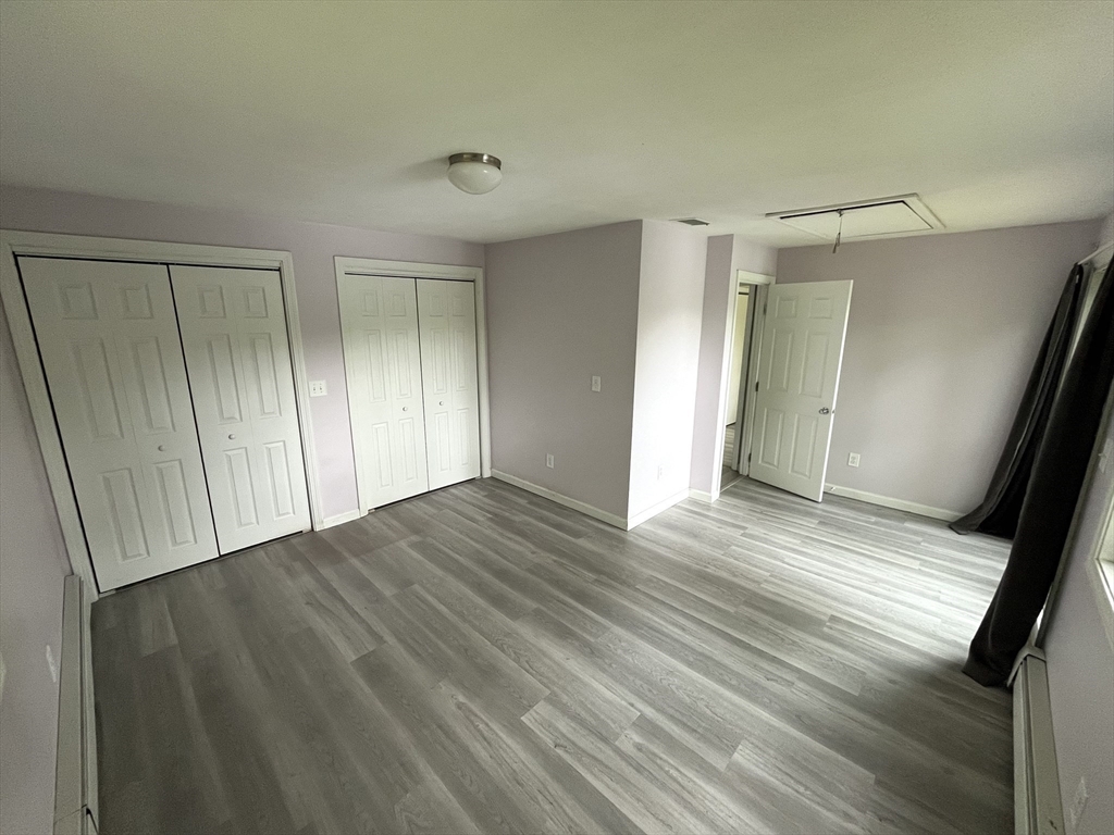 56 Shore Drive Upton, MA 01568 - Photo 13 of 23 a view of an empty room with wooden floor and a window
