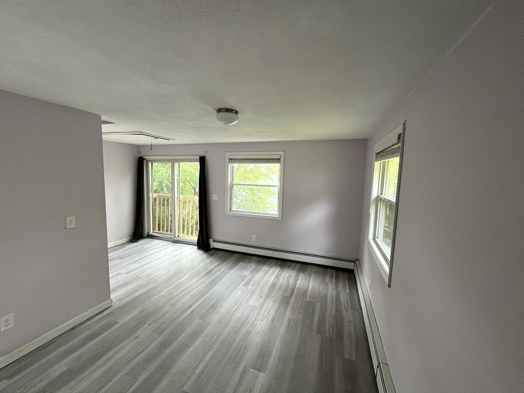 56 Shore Drive Upton, MA 01568 - Photo 14 of 23 an empty room with wooden floor and windows