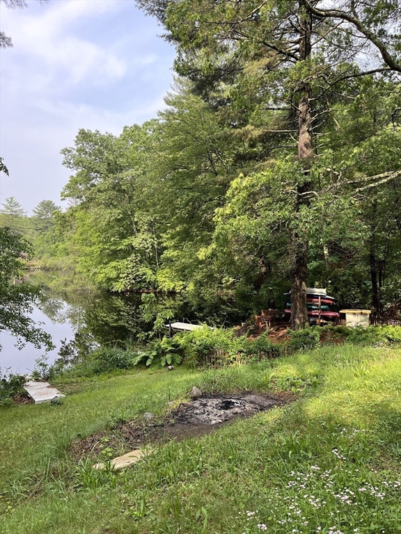 56 Shore Drive Upton, MA 01568 - Photo 21 of 23 a backyard of a house with table and chairs