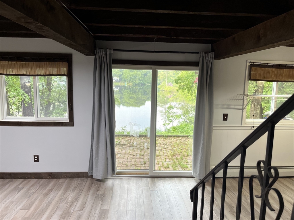 56 Shore Drive Upton, MA 01568 - Photo 10 of 23 a view of an empty room with wooden floor and a window