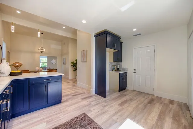 a bedroom with a bed a painting on the wall and a window