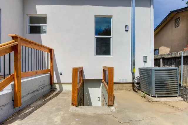 a view of a house with wooden fence