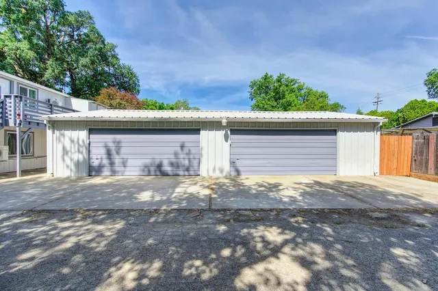 a kitchen with a sink a stove cabinets and wooden floor