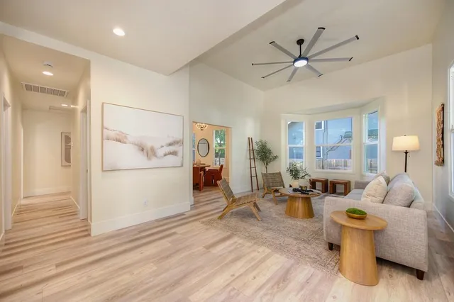 a living room with furniture and a chandelier