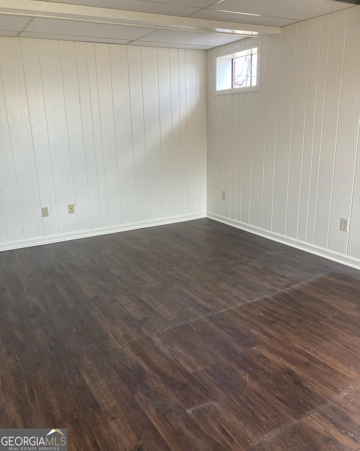 1529 South 1529 S Main Street, Unit 3 Jasper, GA 30143 - Photo 5 of 14 a view of an empty room with wooden floor and a window