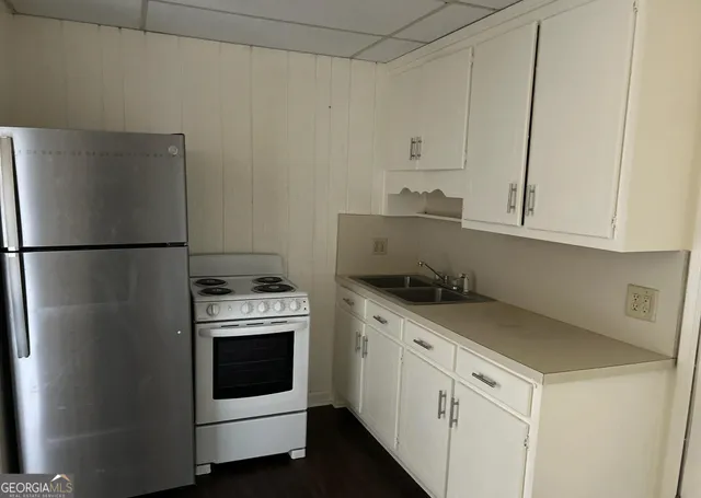 a kitchen with white cabinets