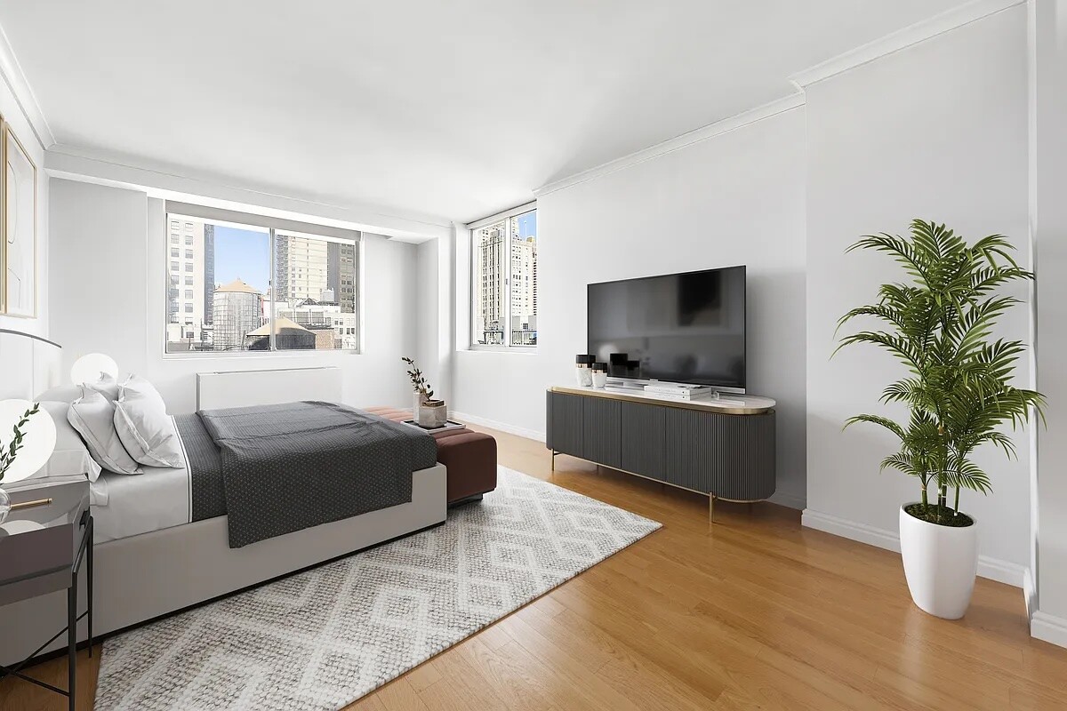50 Lexington Avenue, Unit 22C Manhattan, NY 10010 - Photo 3 of 14 a living room with furniture and a flat screen tv