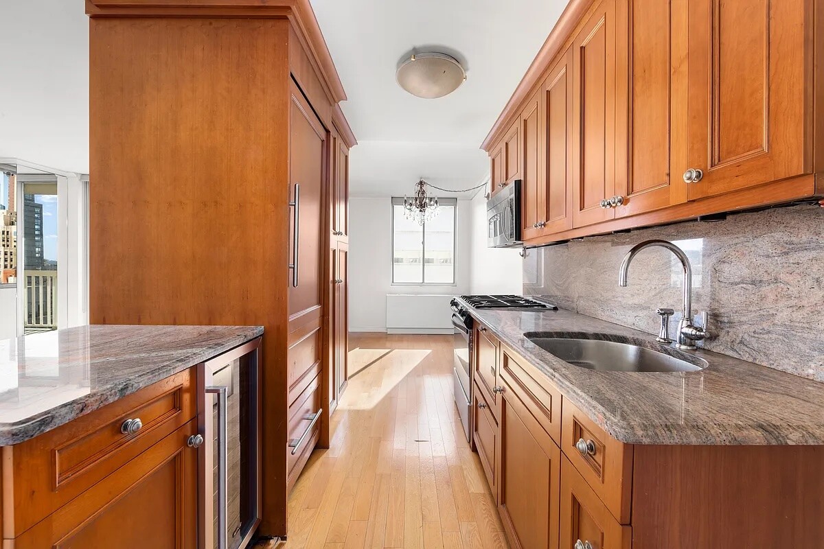 50 Lexington Avenue, Unit 22C Manhattan, NY 10010 - Photo 5 of 14 a kitchen with stainless steel appliances granite countertop a sink stove and cabinets