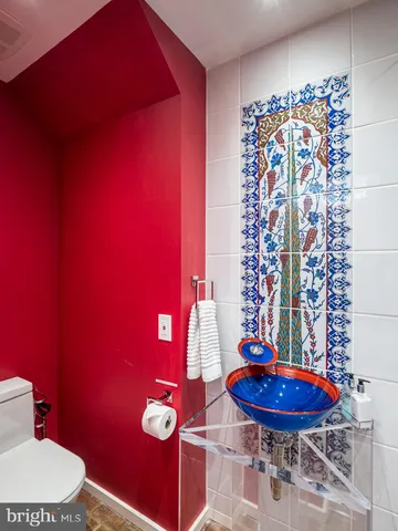 a bathroom with a toilet and a shower curtain