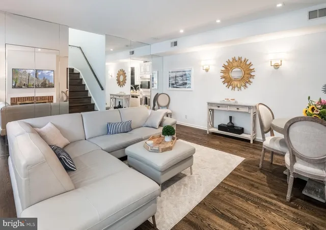 a living room with furniture and a wooden floor