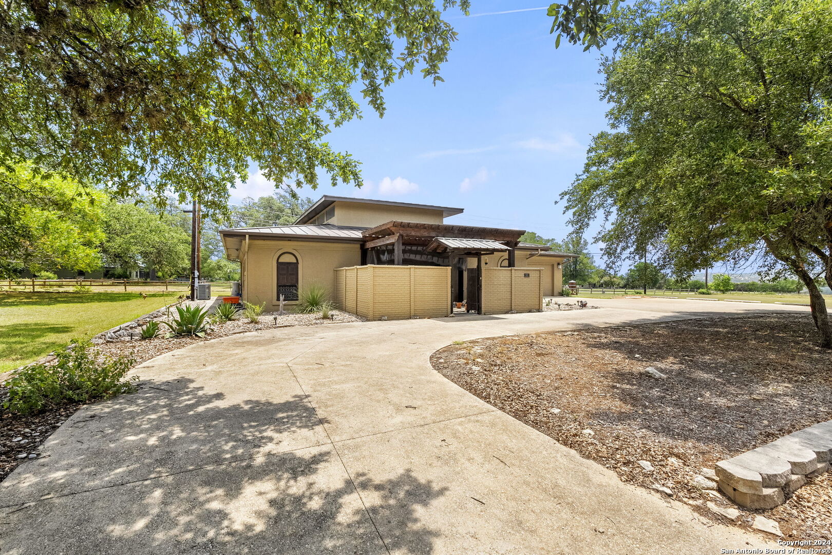 301 Whartons Dock Road Bandera, TX 78003 - Photo 1 of 1 a front view of a house with a yard and garage