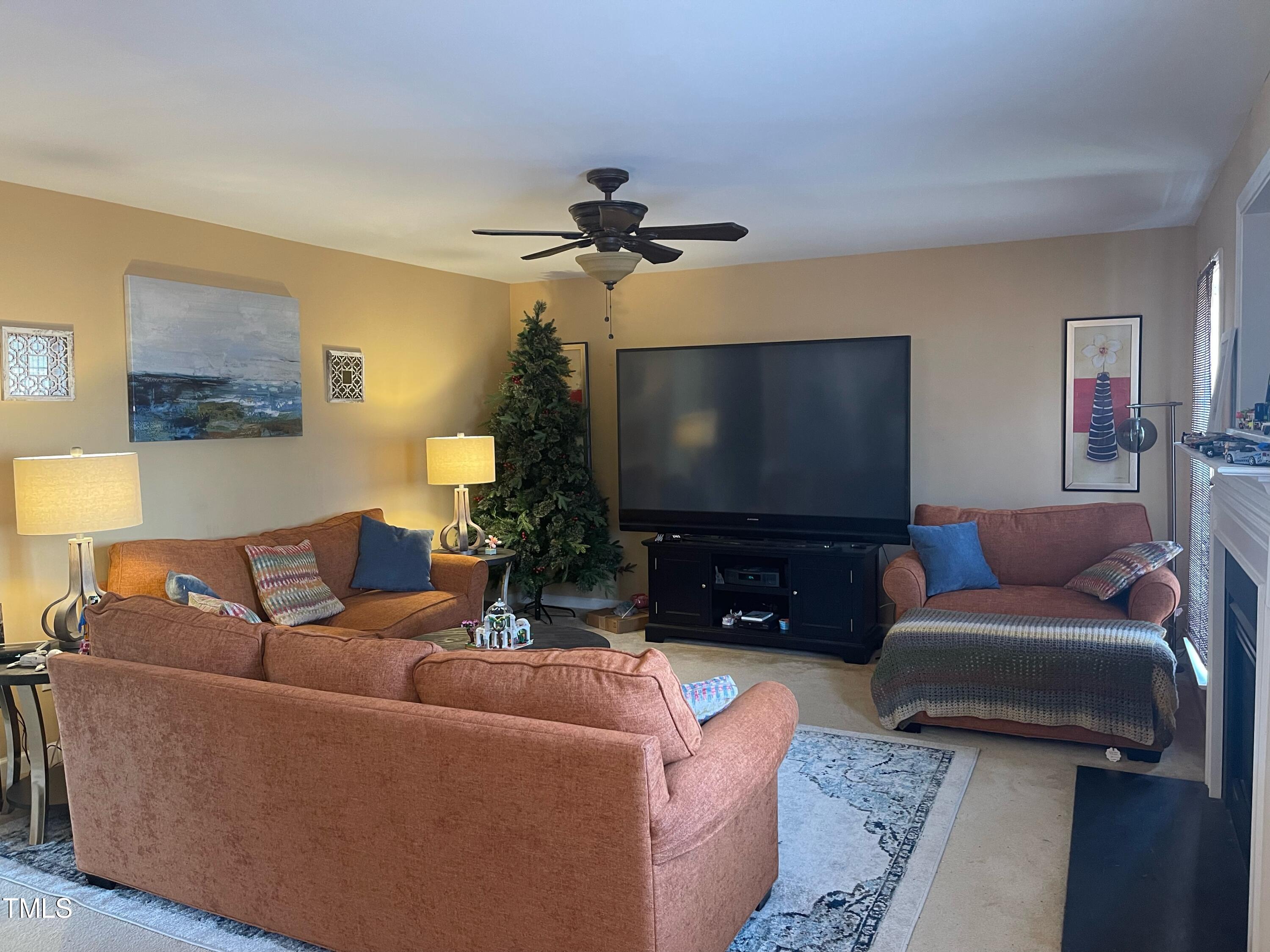 112 Grassy Valley Road Holly Springs, NC 27540 - Photo 16 of 39 a living room with furniture and a flat screen tv