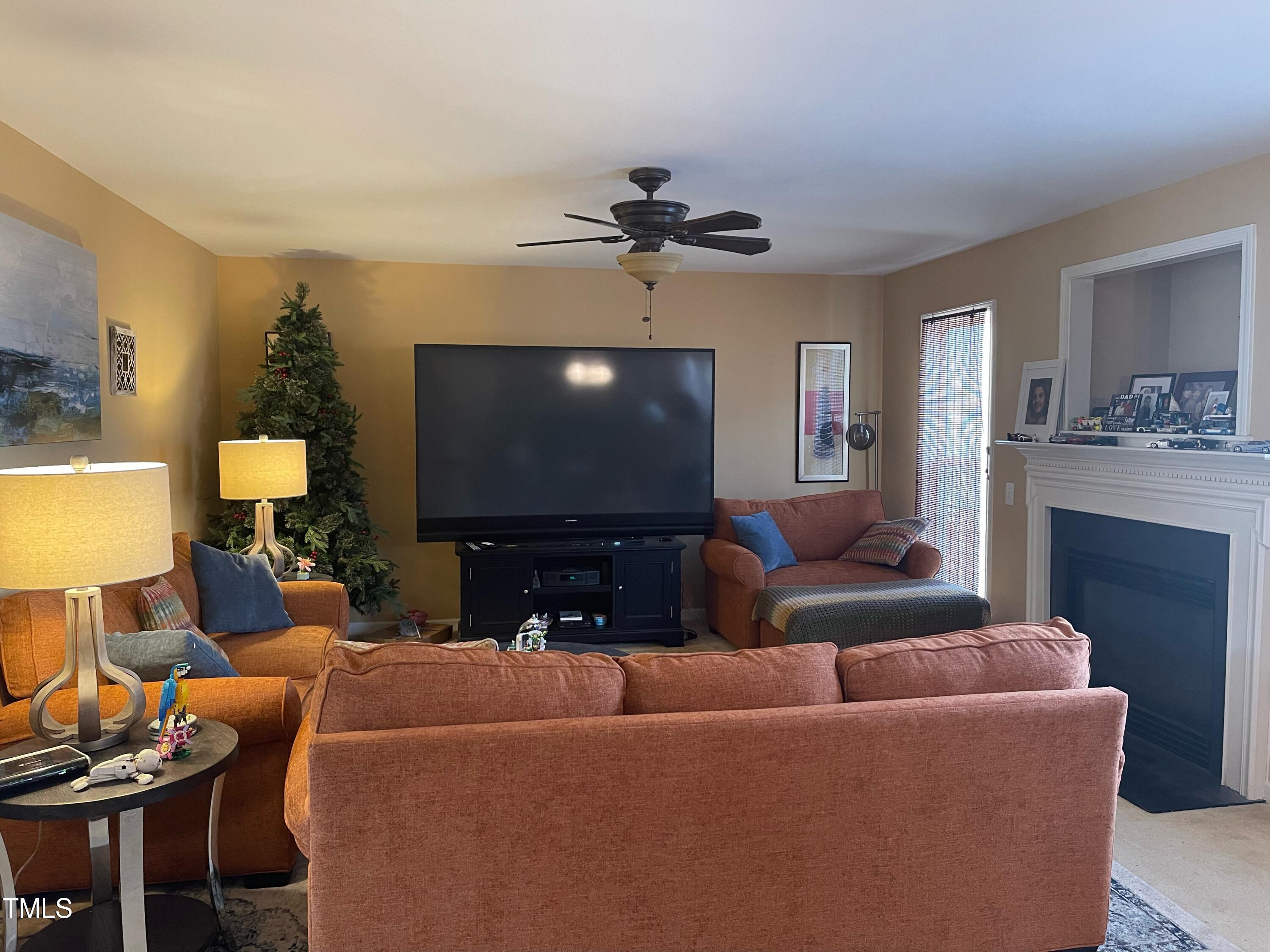 112 Grassy Valley Road Holly Springs, NC 27540 - Photo 17 of 39 a living room with furniture and a flat screen tv
