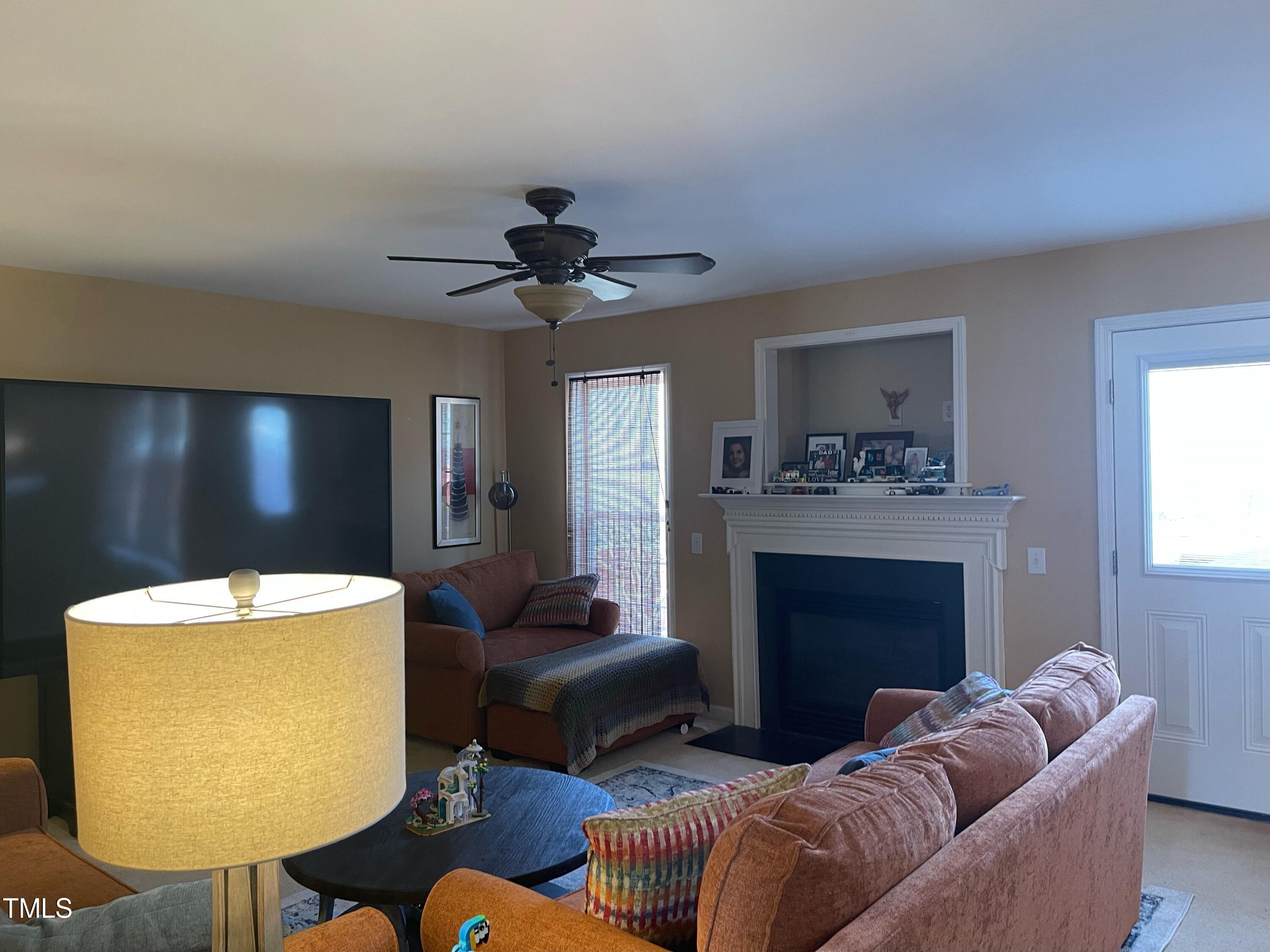 112 Grassy Valley Road Holly Springs, NC 27540 - Photo 18 of 39 a living room with furniture and a fireplace