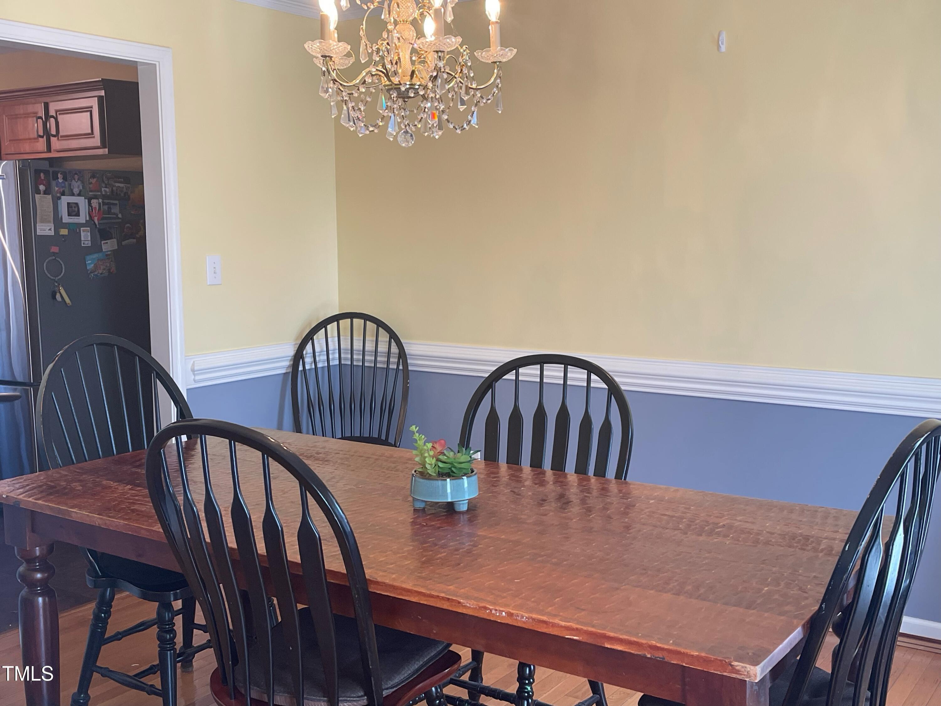 112 Grassy Valley Road Holly Springs, NC 27540 - Photo 19 of 39 a view of a dining room with furniture and wooden floor