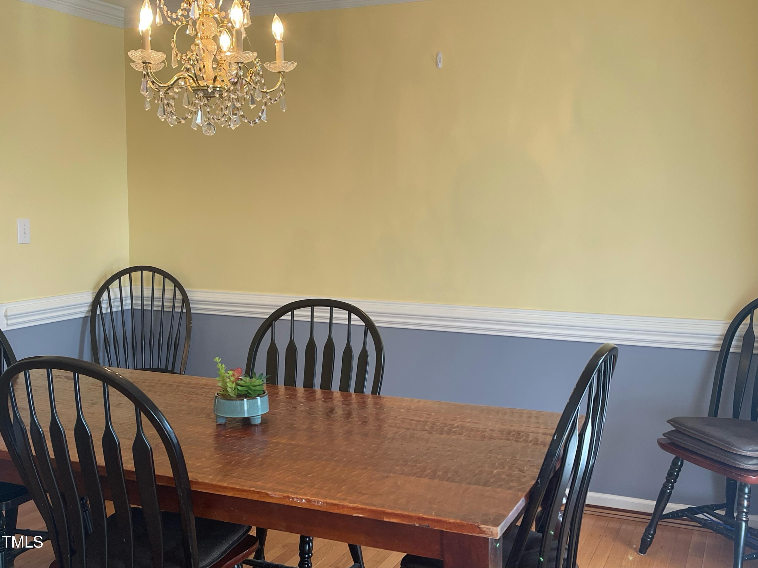 112 Grassy Valley Road Holly Springs, NC 27540 - Photo 20 of 39 a view of a dining room with furniture and chandelier