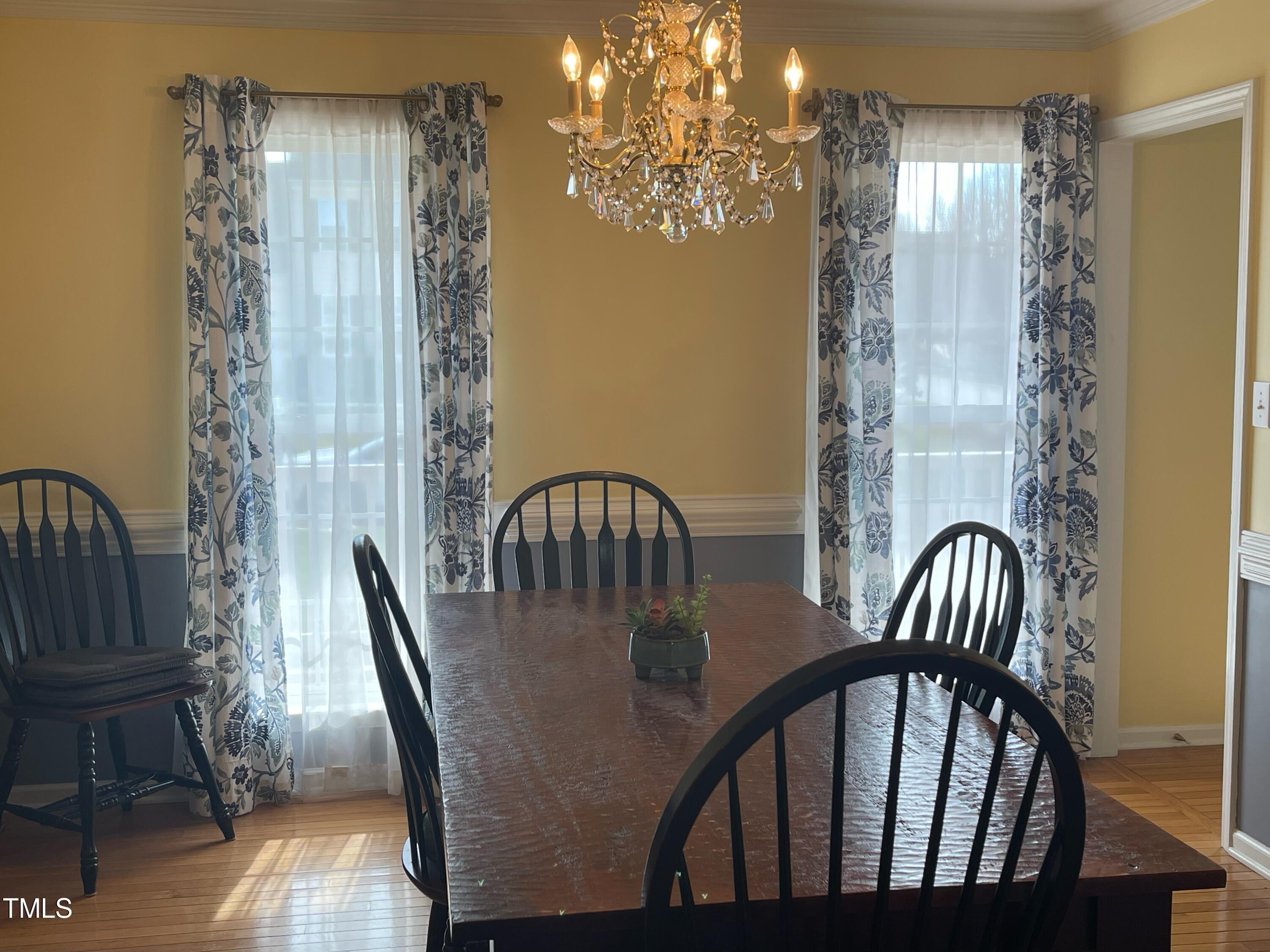 112 Grassy Valley Road Holly Springs, NC 27540 - Photo 21 of 39 a view of a dining room with furniture window and wooden floor