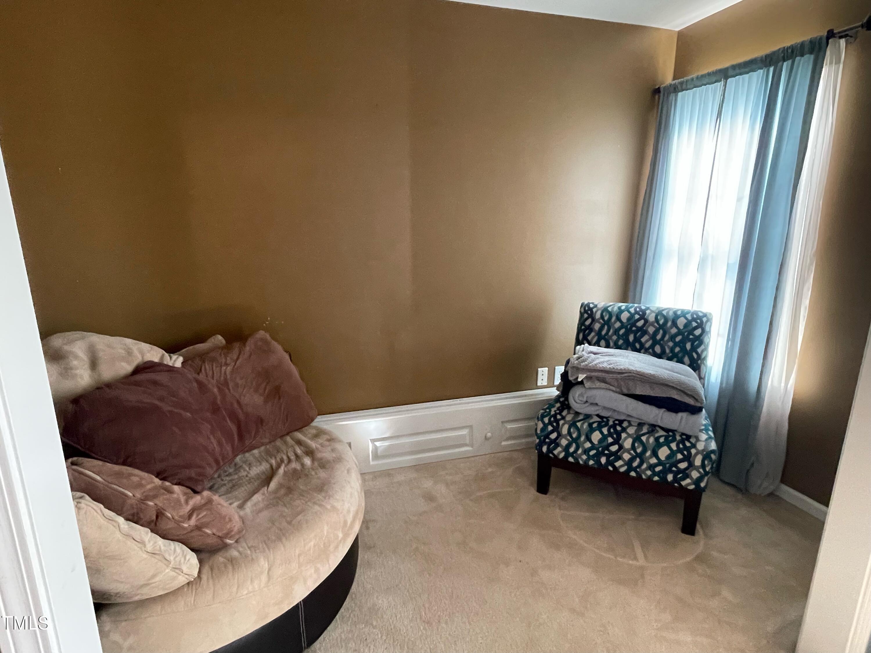 112 Grassy Valley Road Holly Springs, NC 27540 - Photo 27 of 39 a bed sitting in a bedroom next to a window and dresser