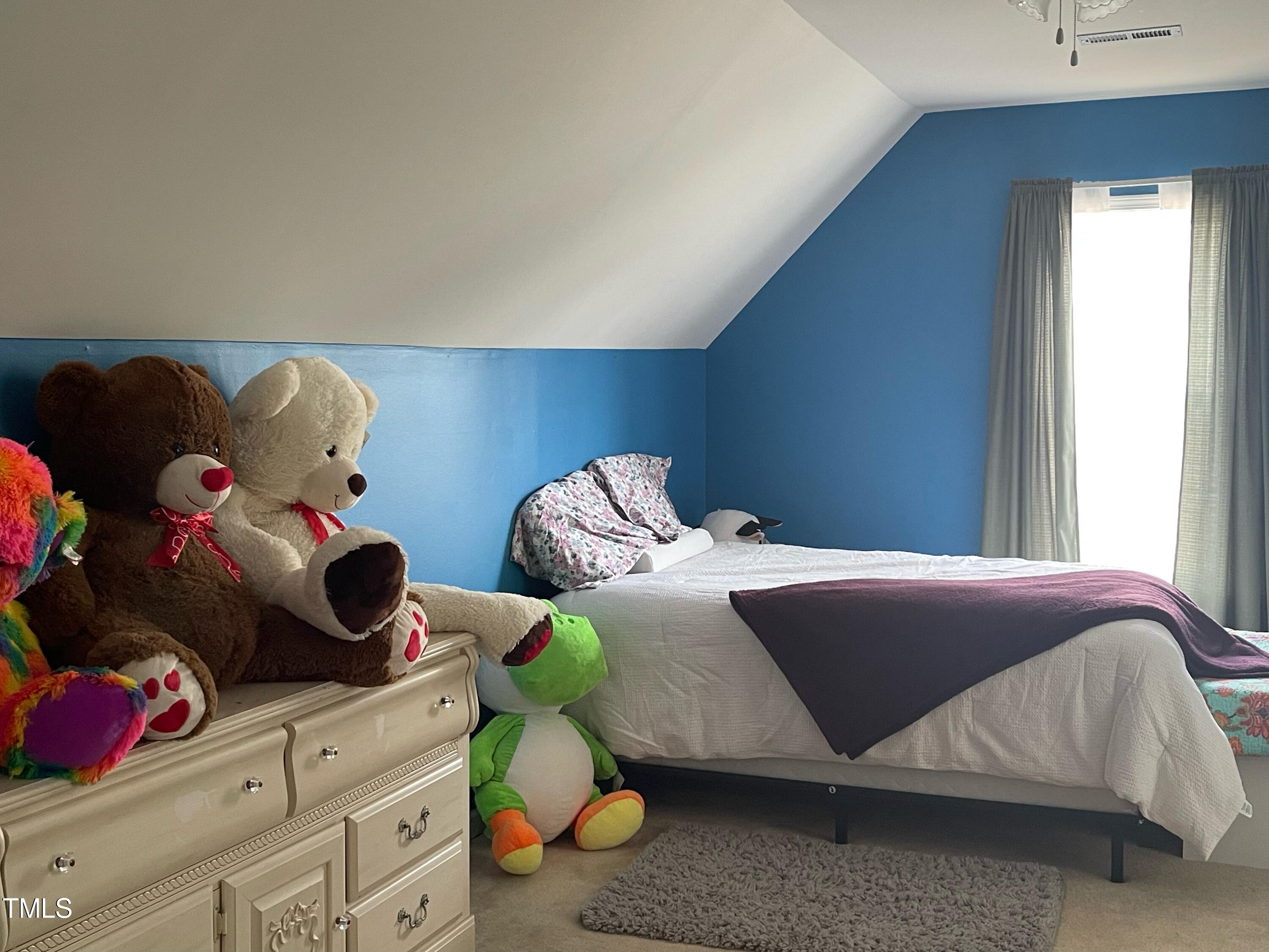 112 Grassy Valley Road Holly Springs, NC 27540 - Photo 37 of 39 a bedroom with a bed and window