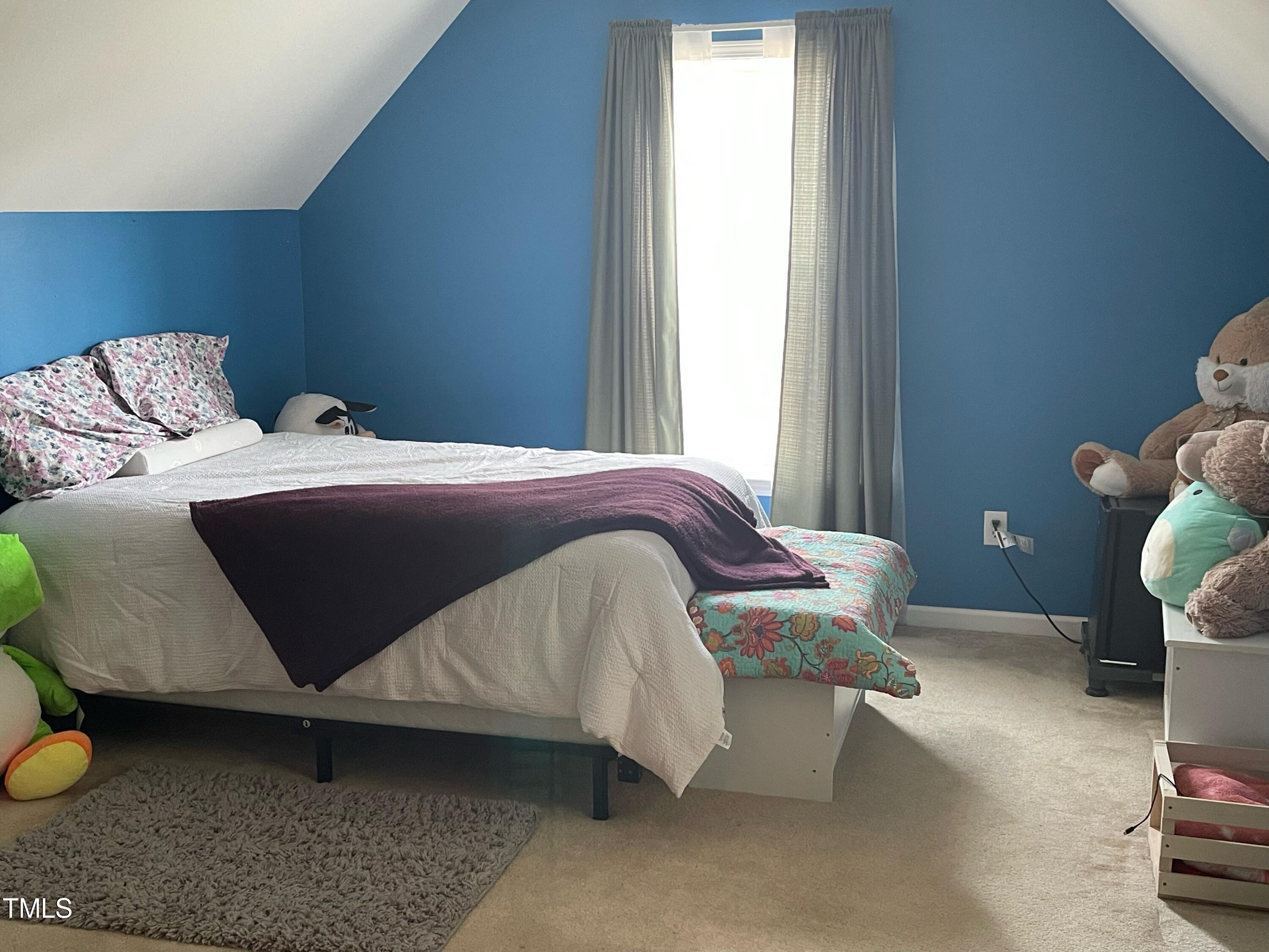 112 Grassy Valley Road Holly Springs, NC 27540 - Photo 39 of 39 a bedroom with a bed and window