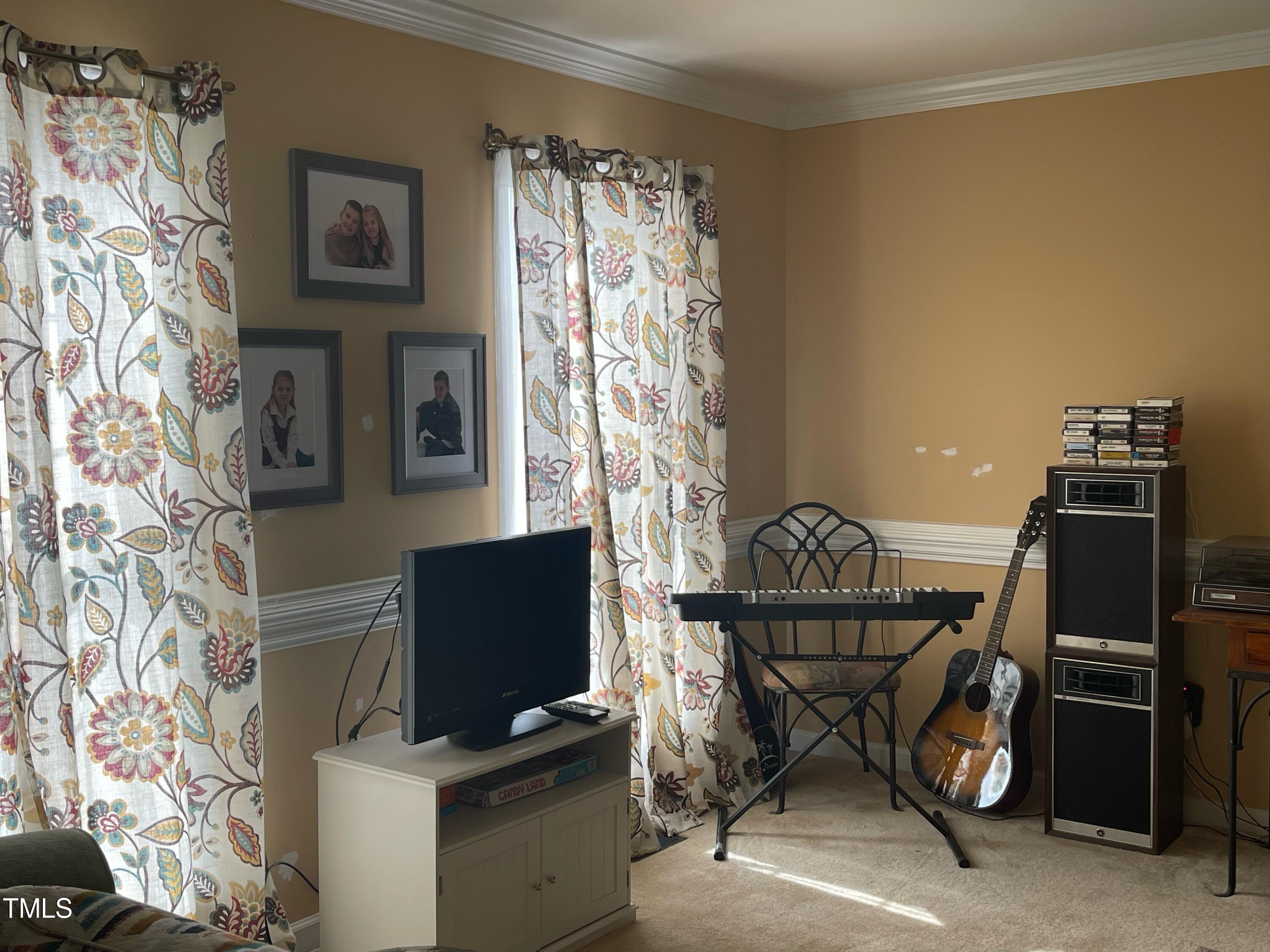 112 Grassy Valley Road Holly Springs, NC 27540 - Photo 10 of 39 a workspace with furniture and a flat screen tv