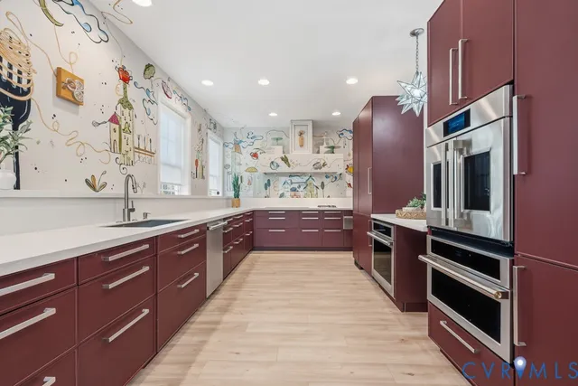 a large kitchen with stainless steel appliances kitchen island granite countertop a refrigerator and a sink