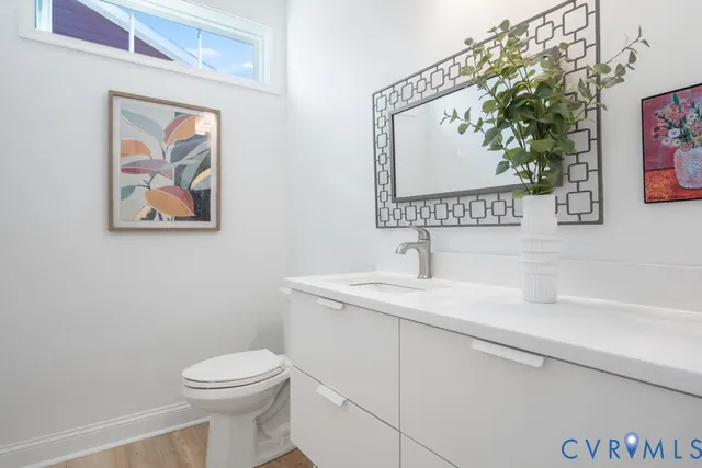 a bathroom with a toilet a sink and mirror