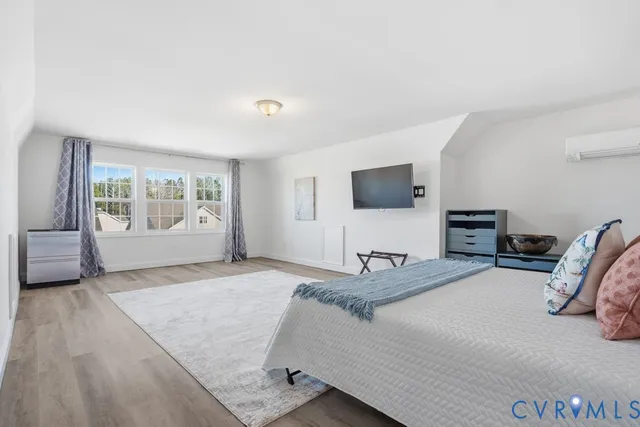 a bedroom with a bed and window