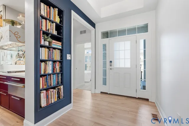 a view of an entryway with wooden floor