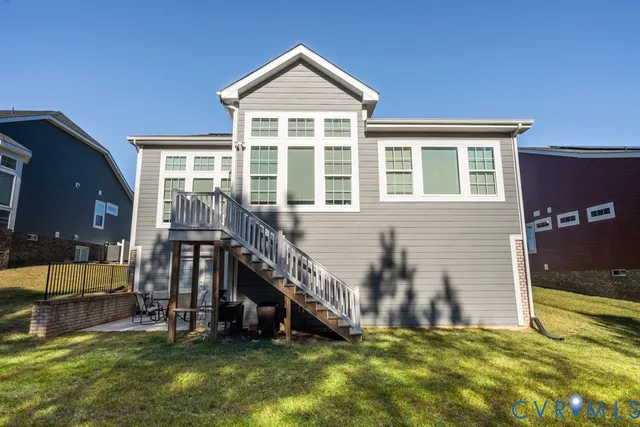 a view of a house with a yard and a large tree