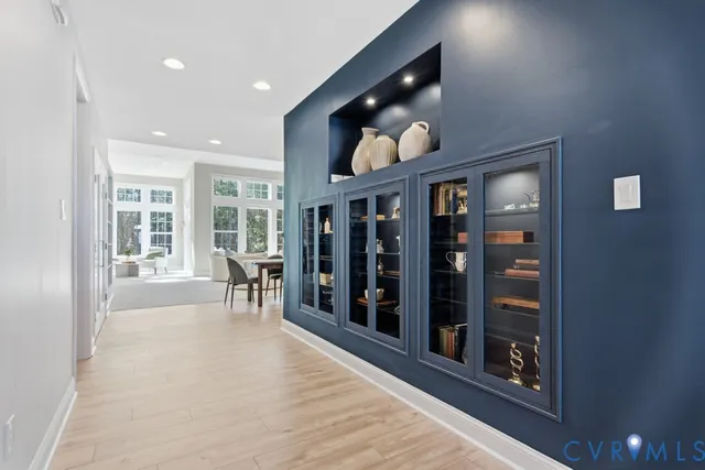 a view of a living room and chandelier with wooden floor