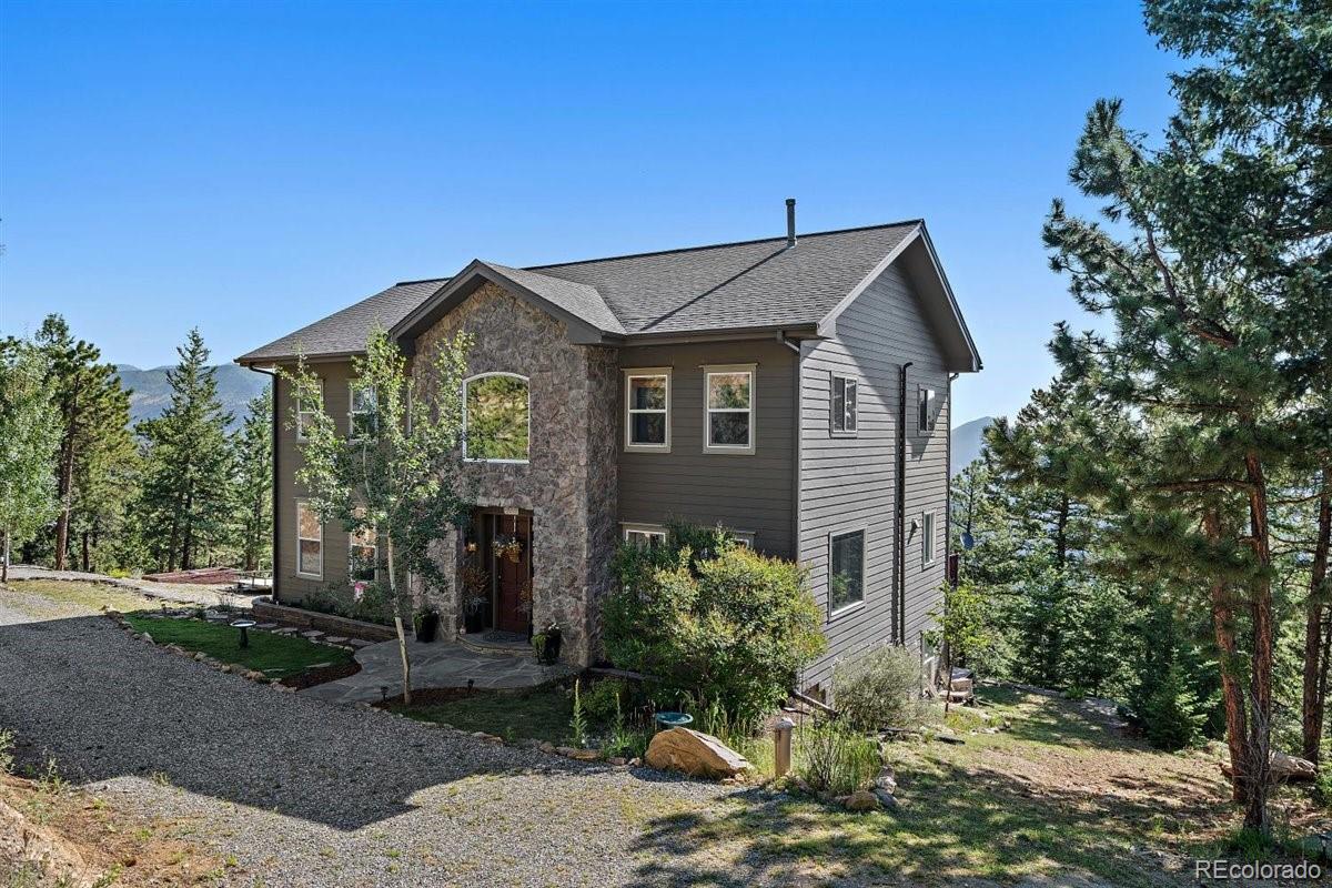 a front view of a house with garden