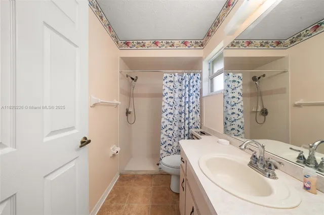 a view of a livingroom with a chandelier fan and a workspace