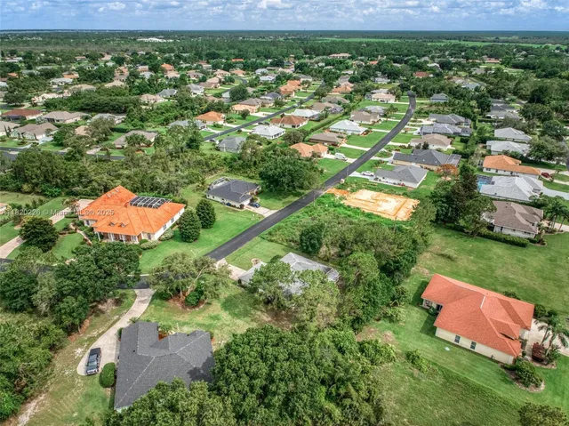 a view of house with a yard and potted plants