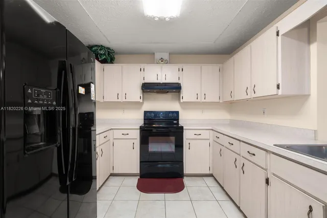 a kitchen with cabinets and stainless steel appliances
