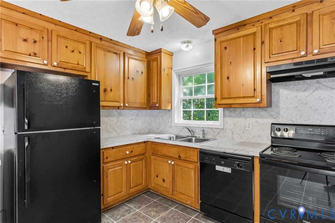 12654 Mt Olive Cohoke Road West Point, VA 23181 - Photo 13 of 31 a kitchen with stainless steel appliances granite countertop a refrigerator stove and sink