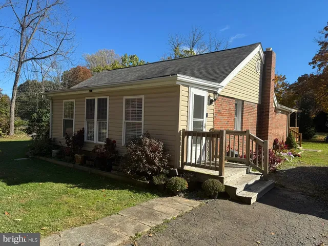 a view of backyard with a garden and deck