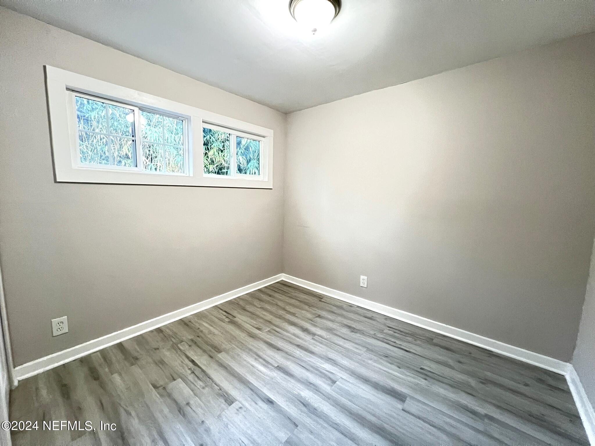 2704 Forman Circle Middleburg, FL 32068 - Photo 11 of 14 a view of an empty room with wooden floor and a window
