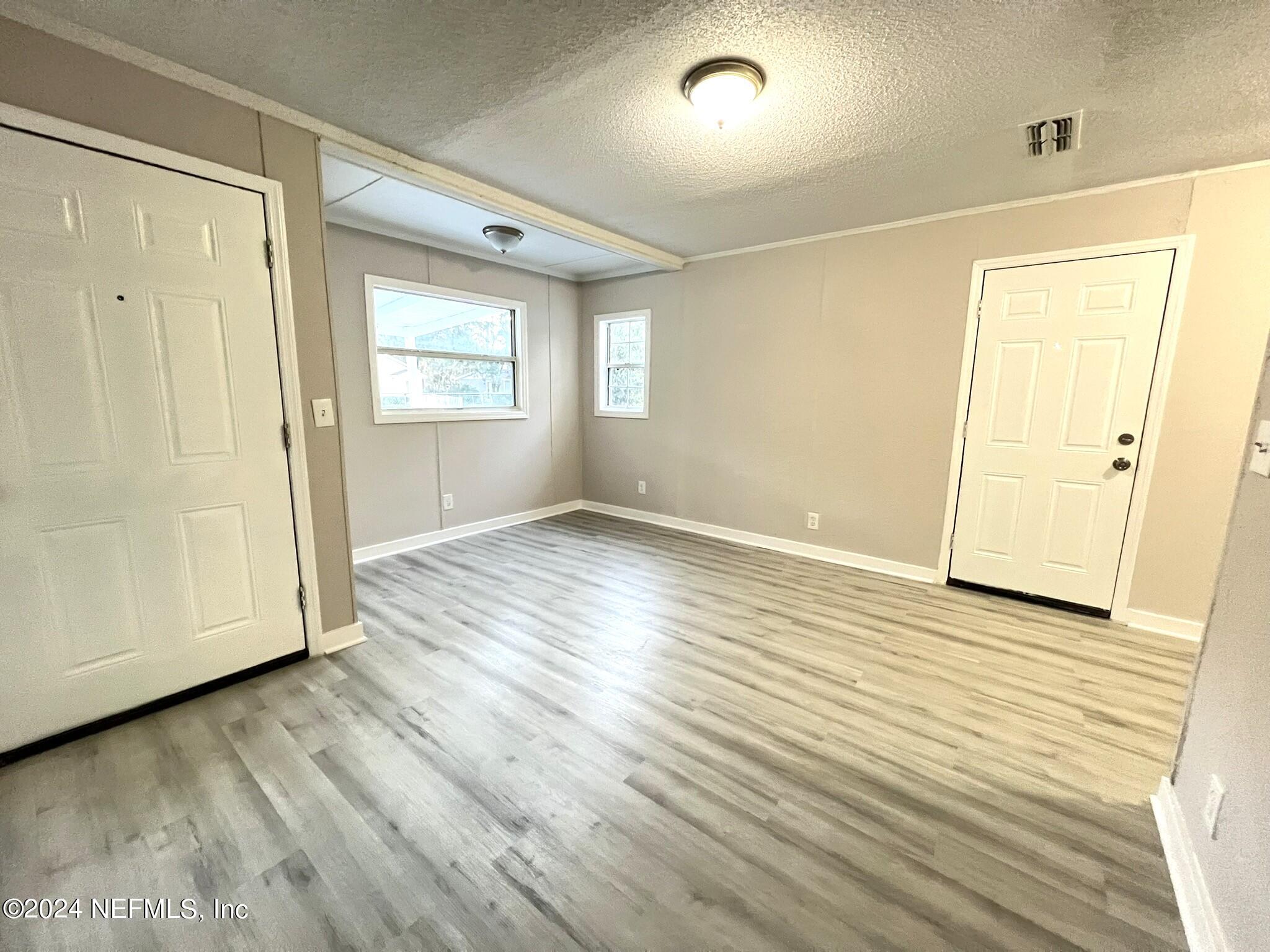 2704 Forman Circle Middleburg, FL 32068 - Photo 2 of 14 an empty room with wooden floor and windows
