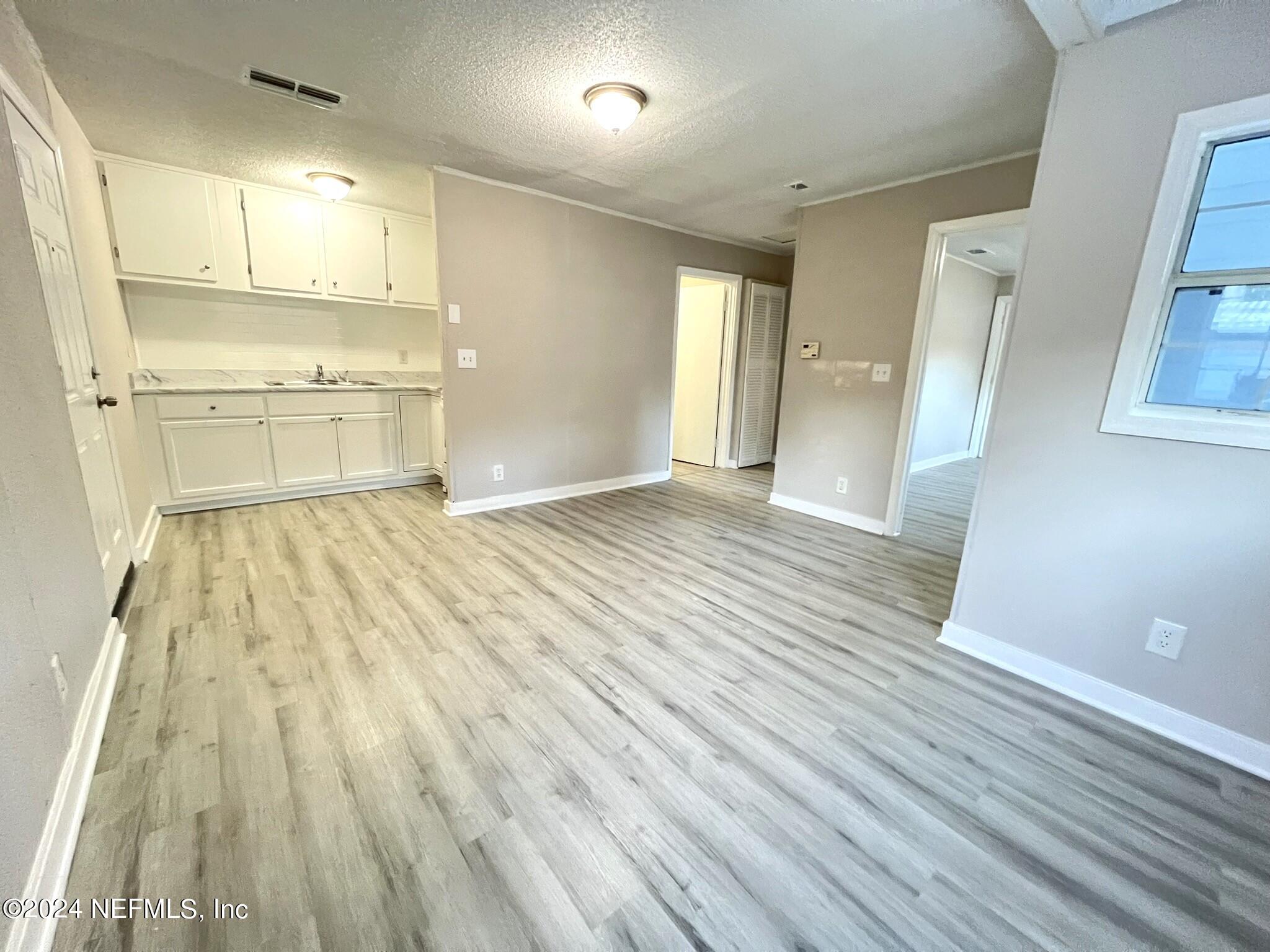 2704 Forman Circle Middleburg, FL 32068 - Photo 3 of 14 a view of a kitchen with wooden floor and a sink